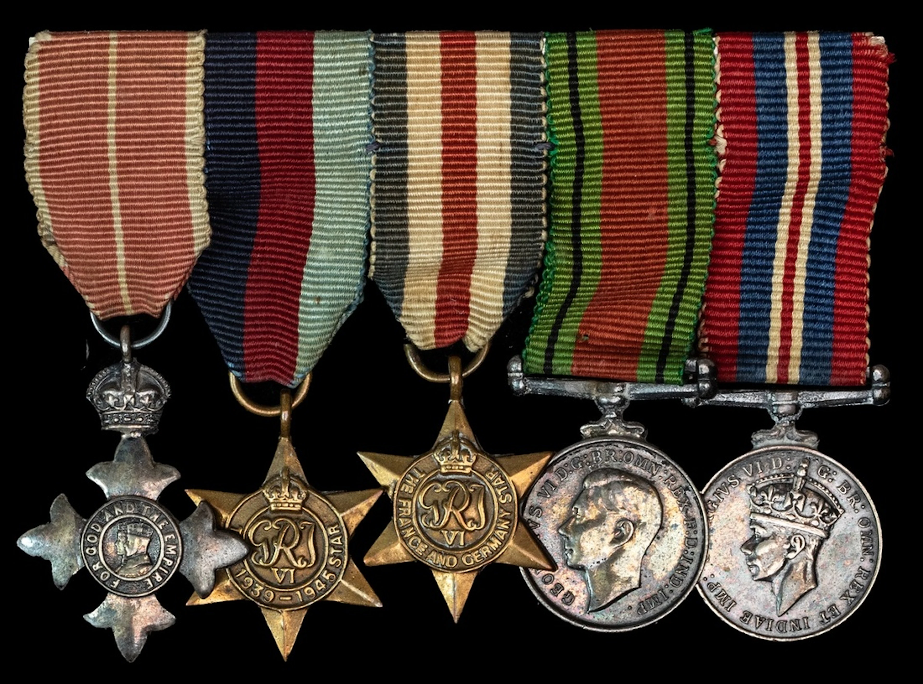 The mounted M.B.E. group of five dress miniatures worn by Major J.