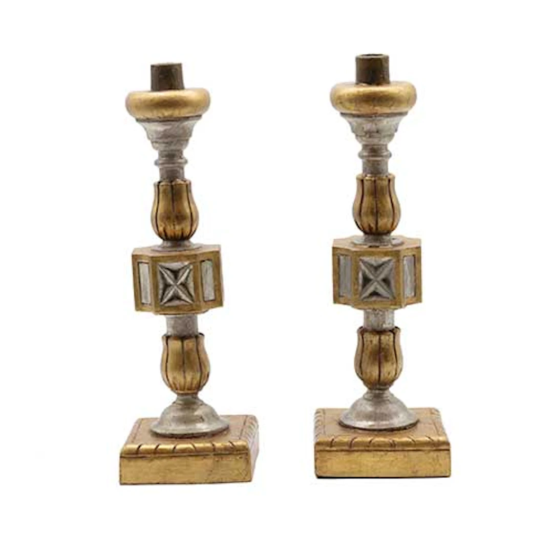 Pareja de candeleros en madera torneada ,tallada, dorada y plateada.