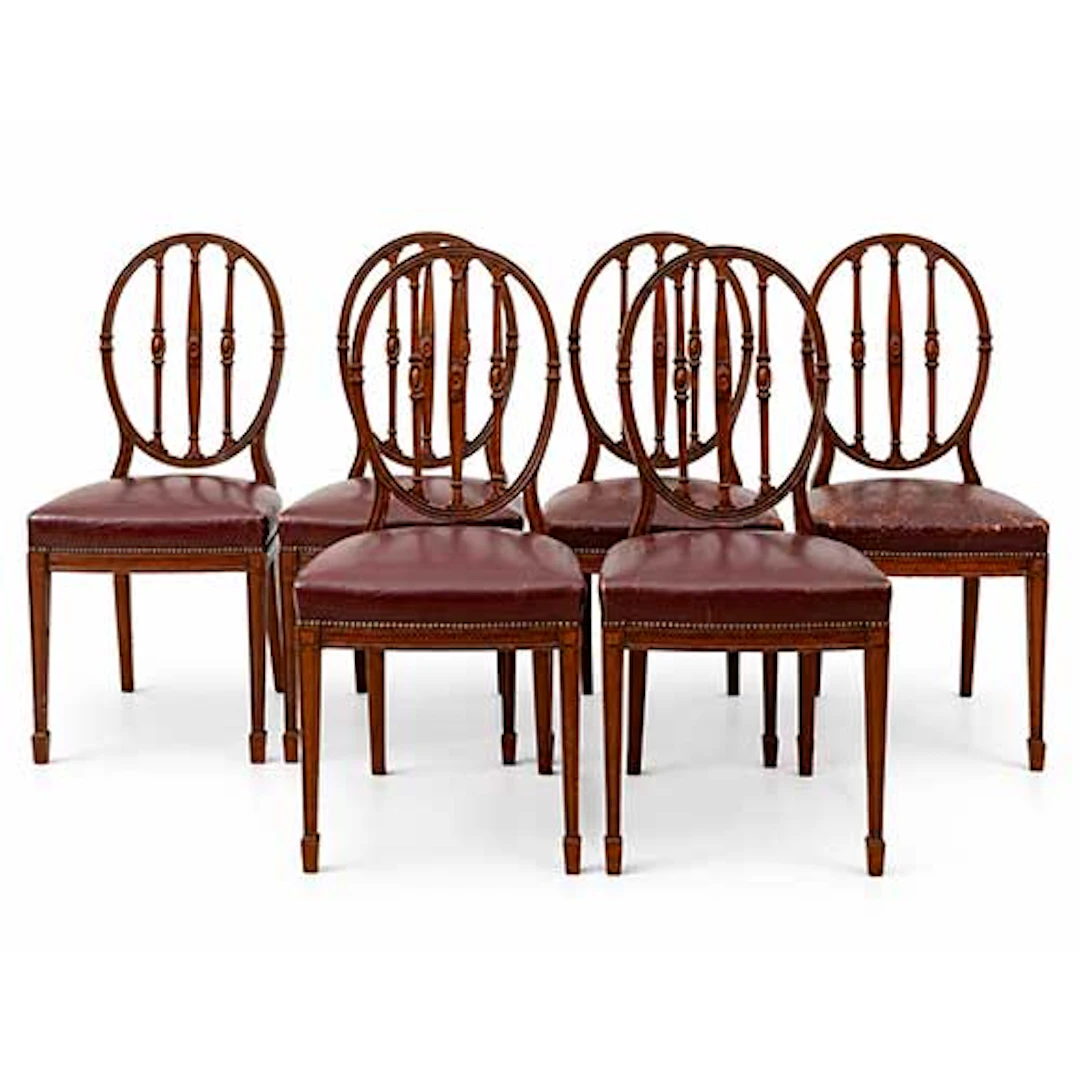 Mesa de comedor y seis sillas tapizadas en piel granate de Simn Loscertales