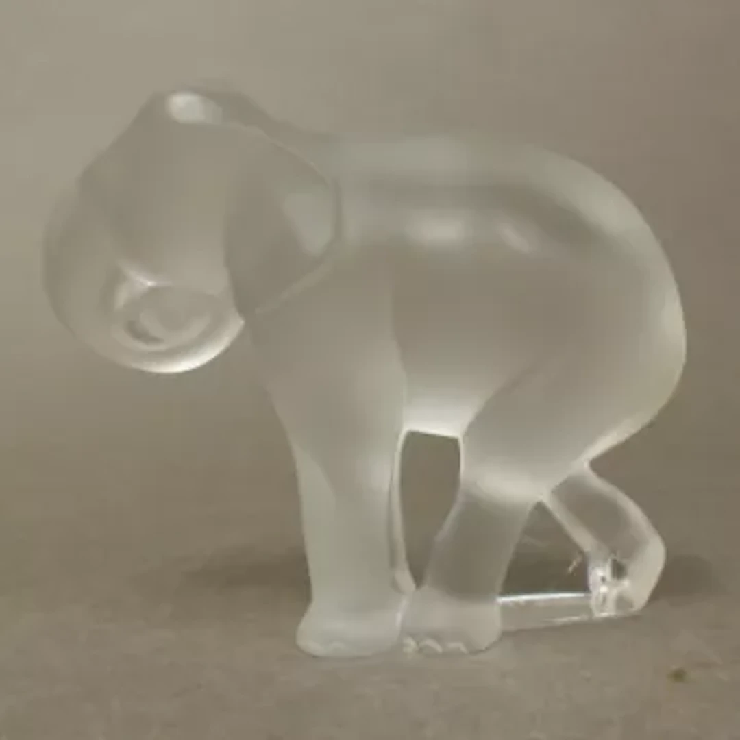 A Lalique Baby Elephant, etched 'Lalique France', height 7.5cm.