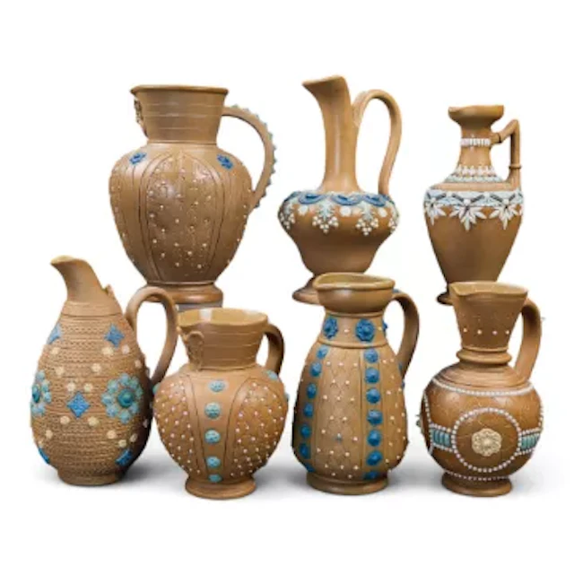 A group of 7 Doulton Lambeth Silicon ware mid sized jugs / ewers