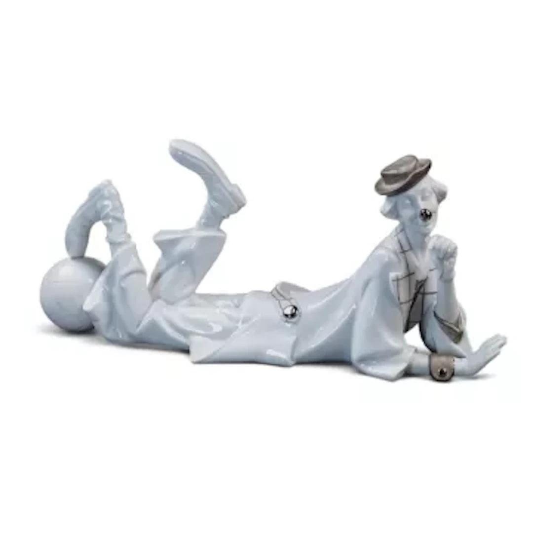 A Lladro figure The Recumbent Clown, model no.4618, designed by Salvador