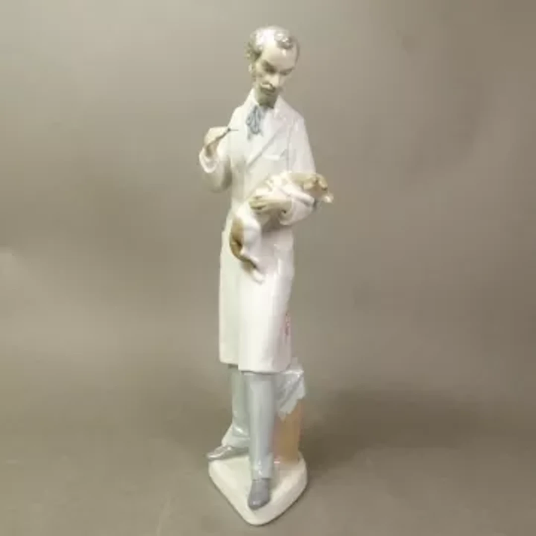 Lladro figure of a Veterinarian model no 4825, head re-glued, height 34cm.