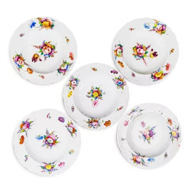 Five Coalport soup plates, early 19th Century, all with floral decoration