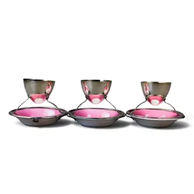 A set of three Royal Doulton egg cups on stands, designed by Dr Christopher