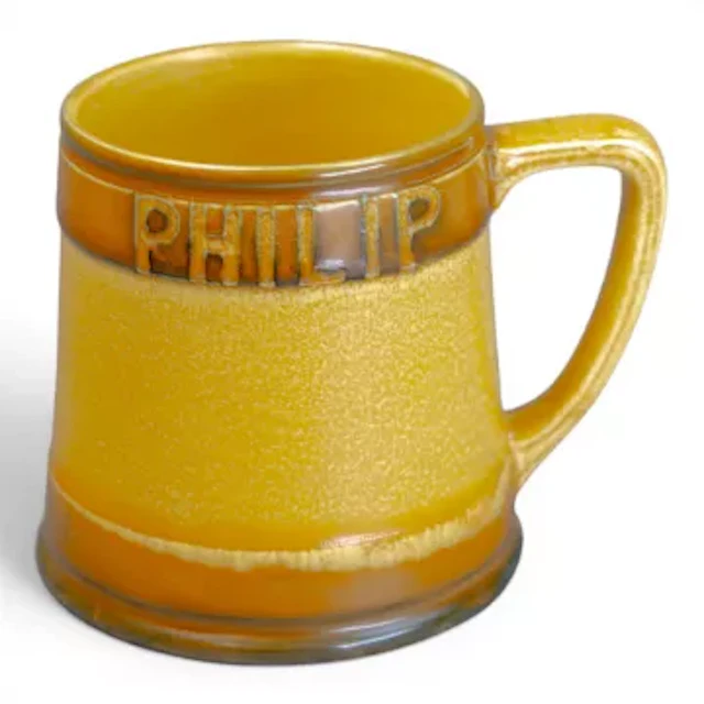 A large Moorcroft tankard, decorated in a caramel glaze, by William