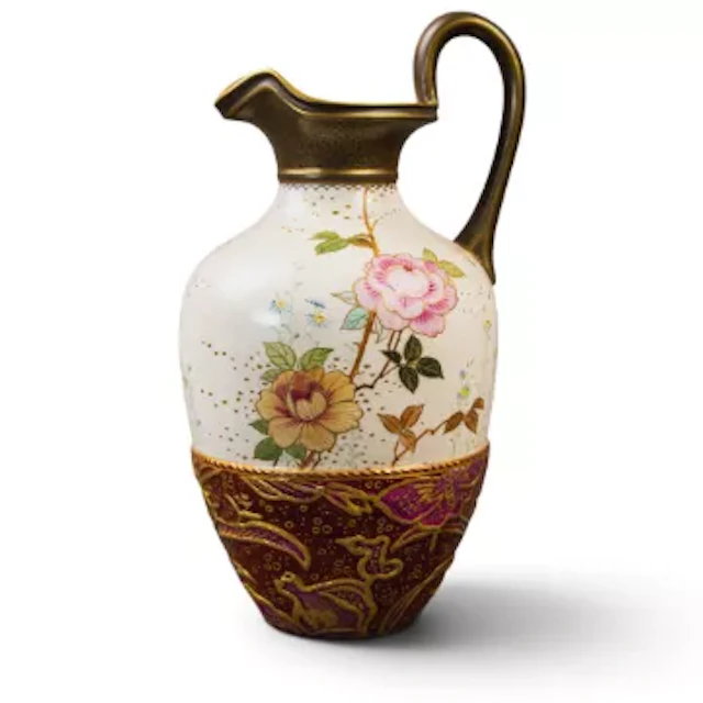A Doulton Burslem ewer with a strap handle and shaped rim, decorated