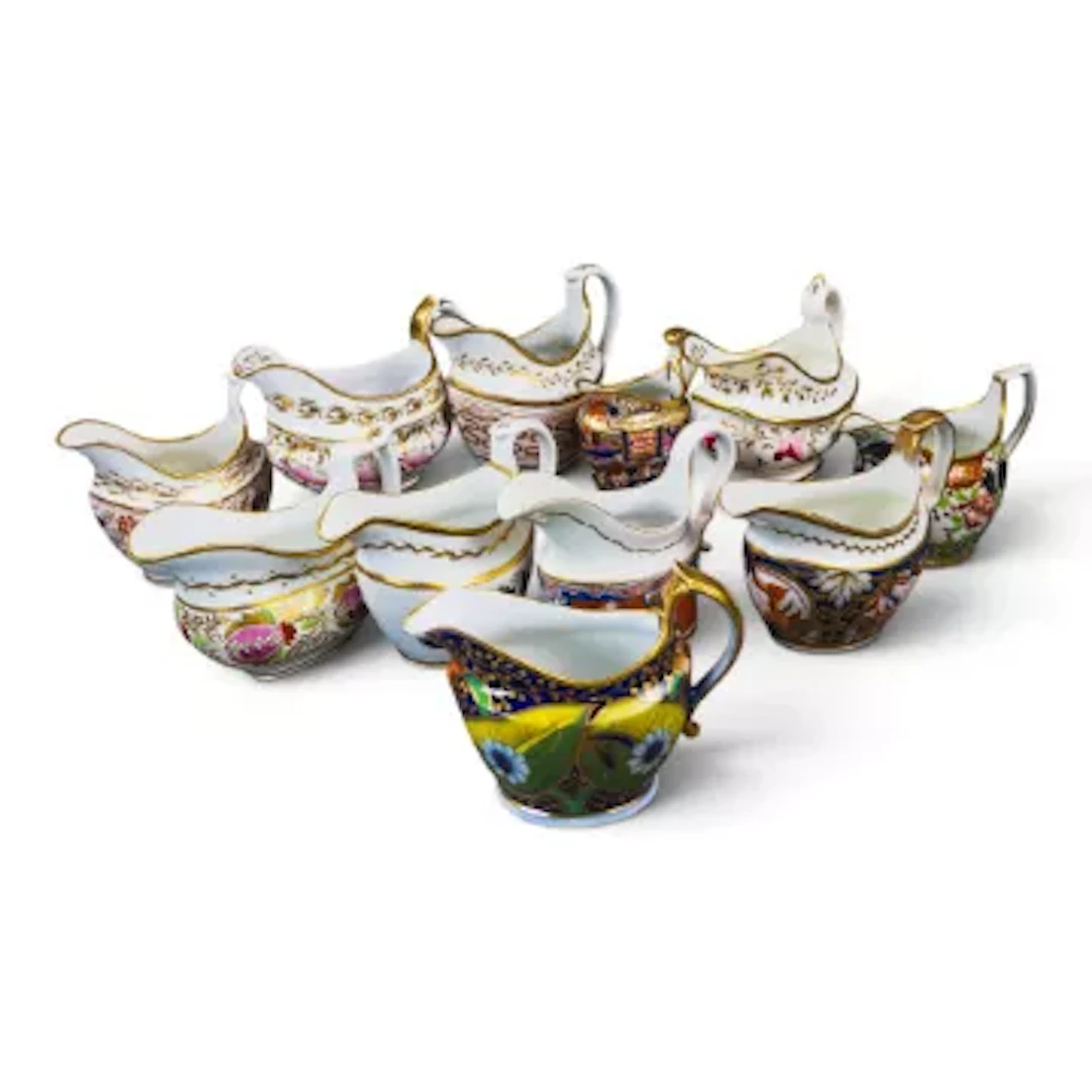 A group of 11 English porcelain 19th century cream jugs by various