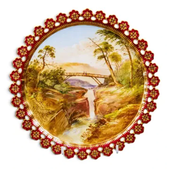 A 19th Century Coalport hand painted plate, with cut and pierced rim