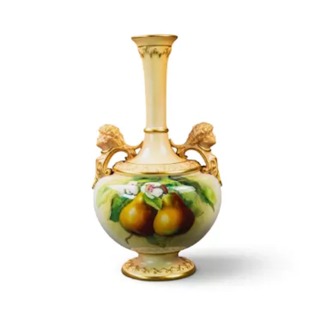 A Royal Worcester vase on a pedestal foot with twin handles each featuring