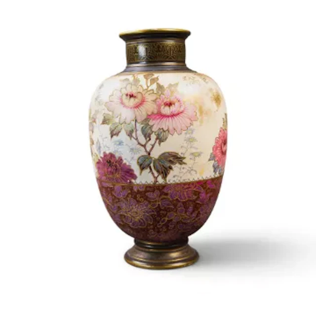 A Doulton Burslem vase on a pedestal foot, decorated with a floral