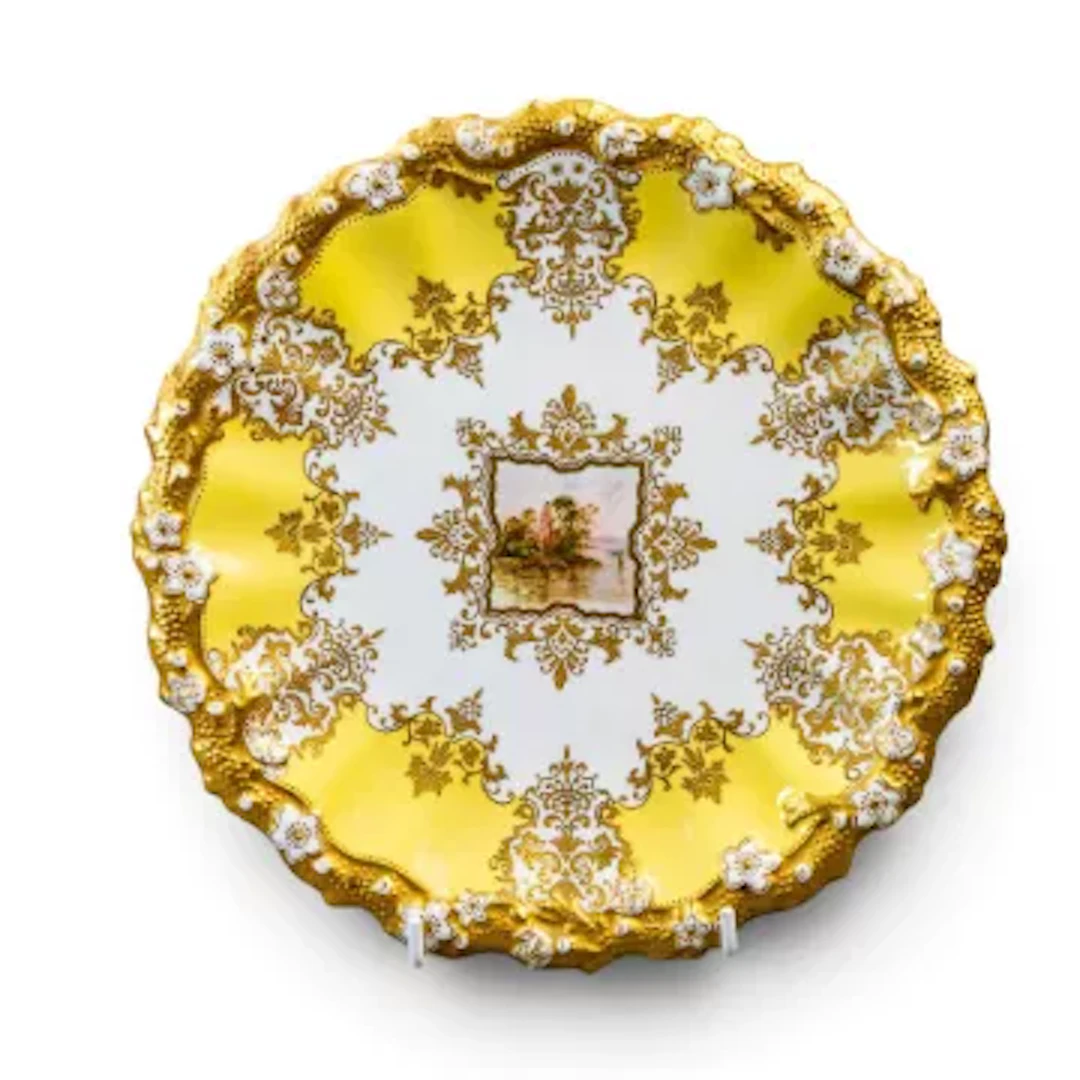 A late 19th Century Coalport plate with fluted rim in Rococo style