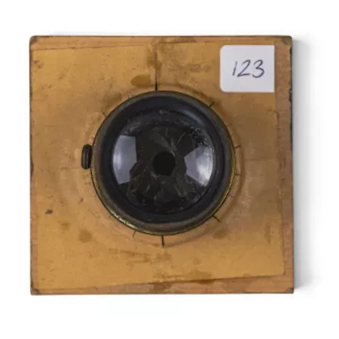 Small brass camera lens barrel featuring rack-and-pinion focusing