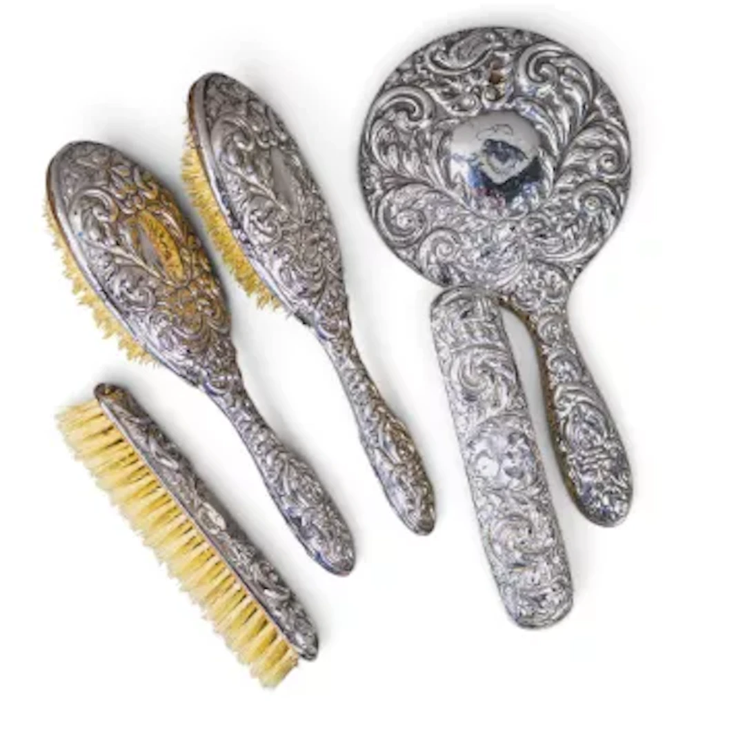 Antique silver handled vanity set, comprising hand mirror and 4 brushes