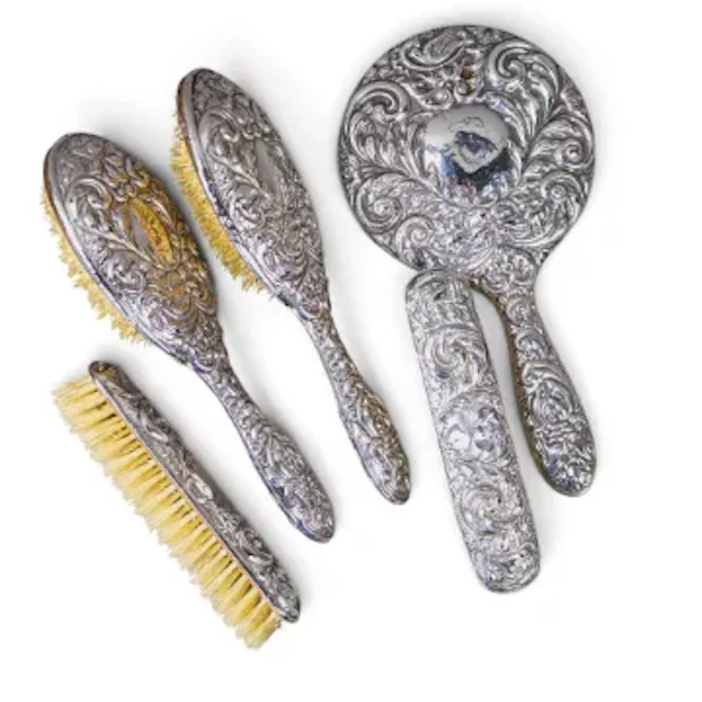 Antique silver handled vanity set, comprising hand mirror and 4 brushes