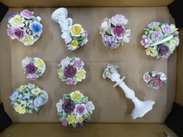 A collection of ceramic floral fancies, including Royal Doulton examples