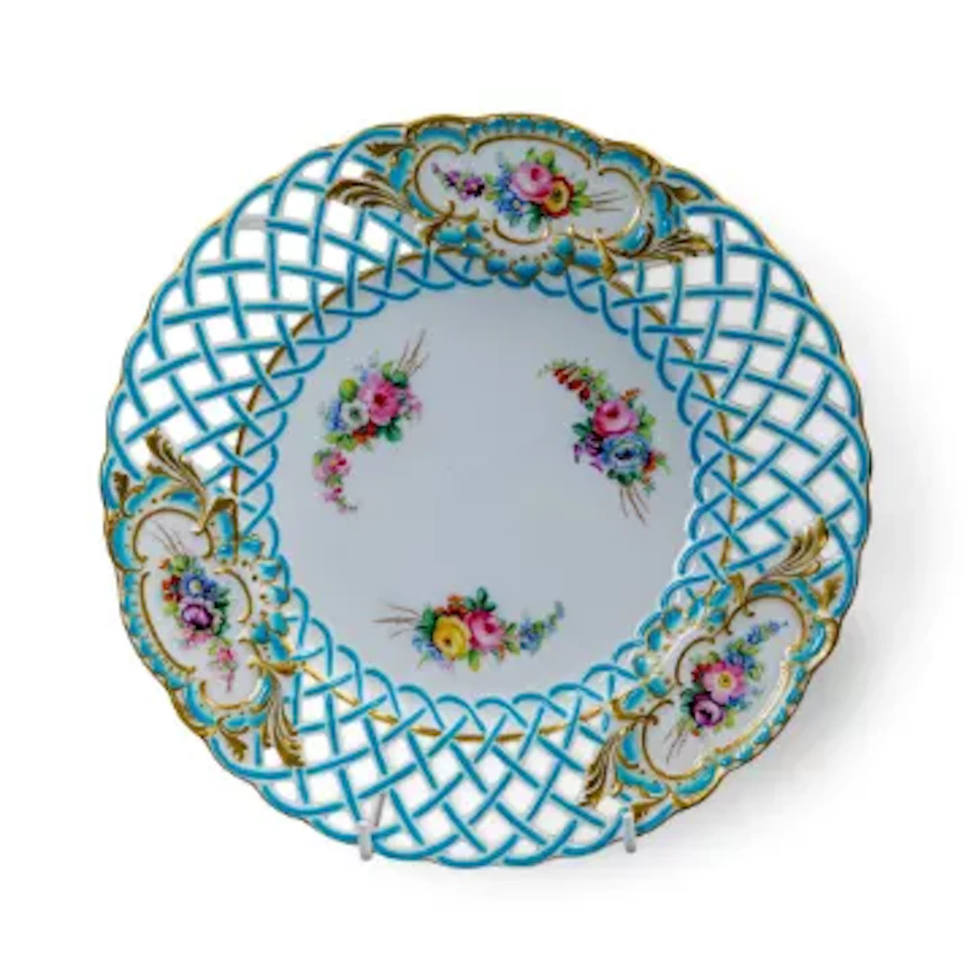 A 19th Century Minton plate with reticulated rim, decorated with floral