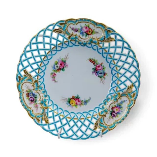 A 19th Century Minton plate with reticulated rim, decorated with floral