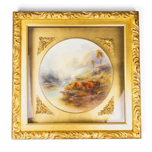 A framed Royal Worcester plate featuring Highland cattle in a landscape