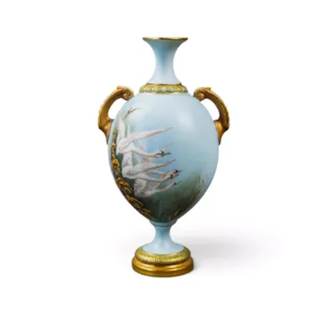 A Royal Worcester twin handled vase on a pedestal foot, decorated