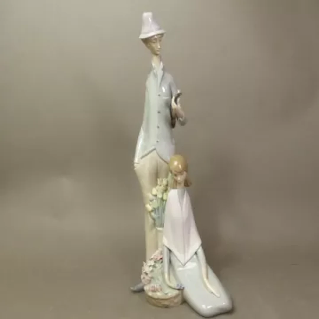 Lladro figural group of man with violin and lady seated, model 1039
