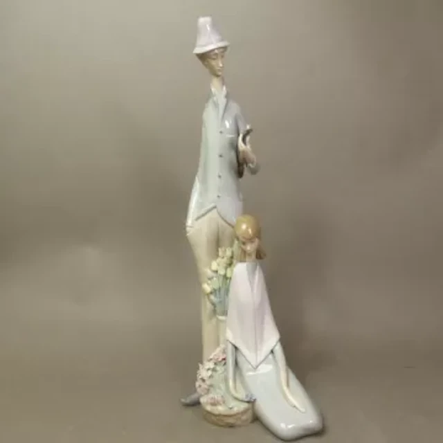 Lladro figural group of man with violin and lady seated, model 1039
