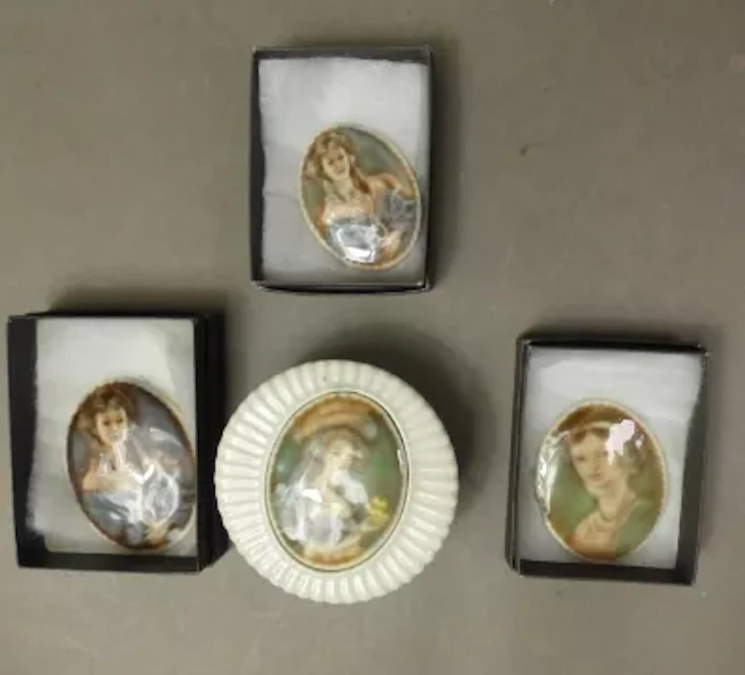 Three Irish Wade portrait brooches, together with a lidded box with