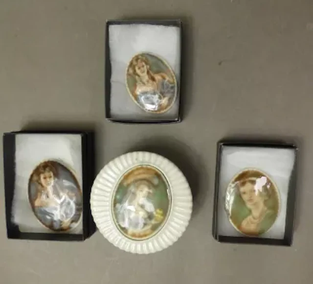 Three Irish Wade portrait brooches, together with a lidded box with