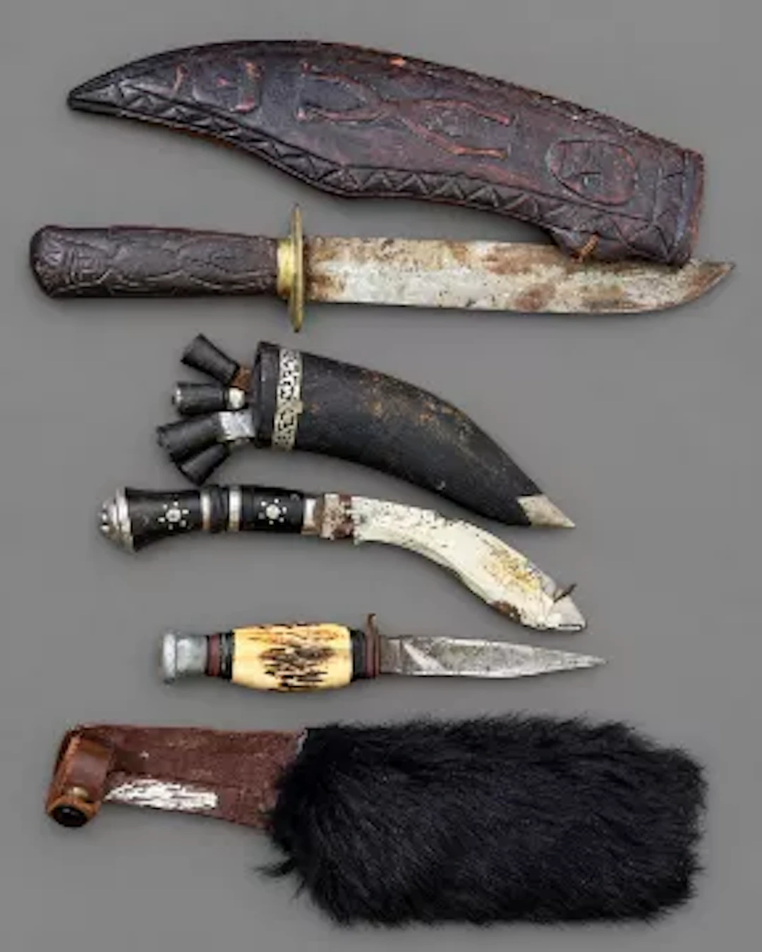 Three collectors knives, an African knife in hand carved sheaf, an