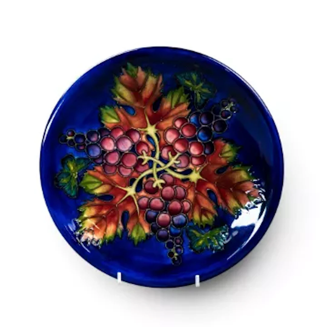 A rare Moorcroft plate in the Vine Harvest pattern designed by Sally