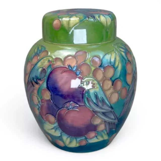 A Moorcroft Finches ginger jar on a green ground by Sally Tuffin