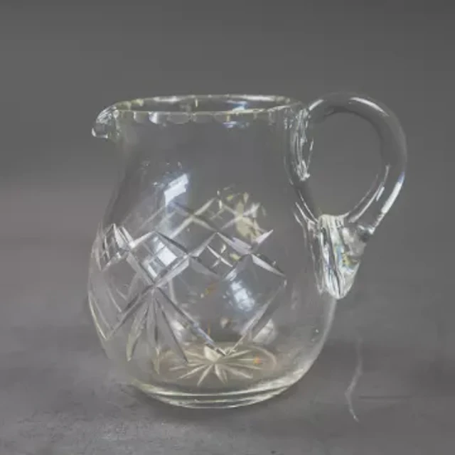 A cut crystal glass pitcher, cut diamond shaped pattern to body and