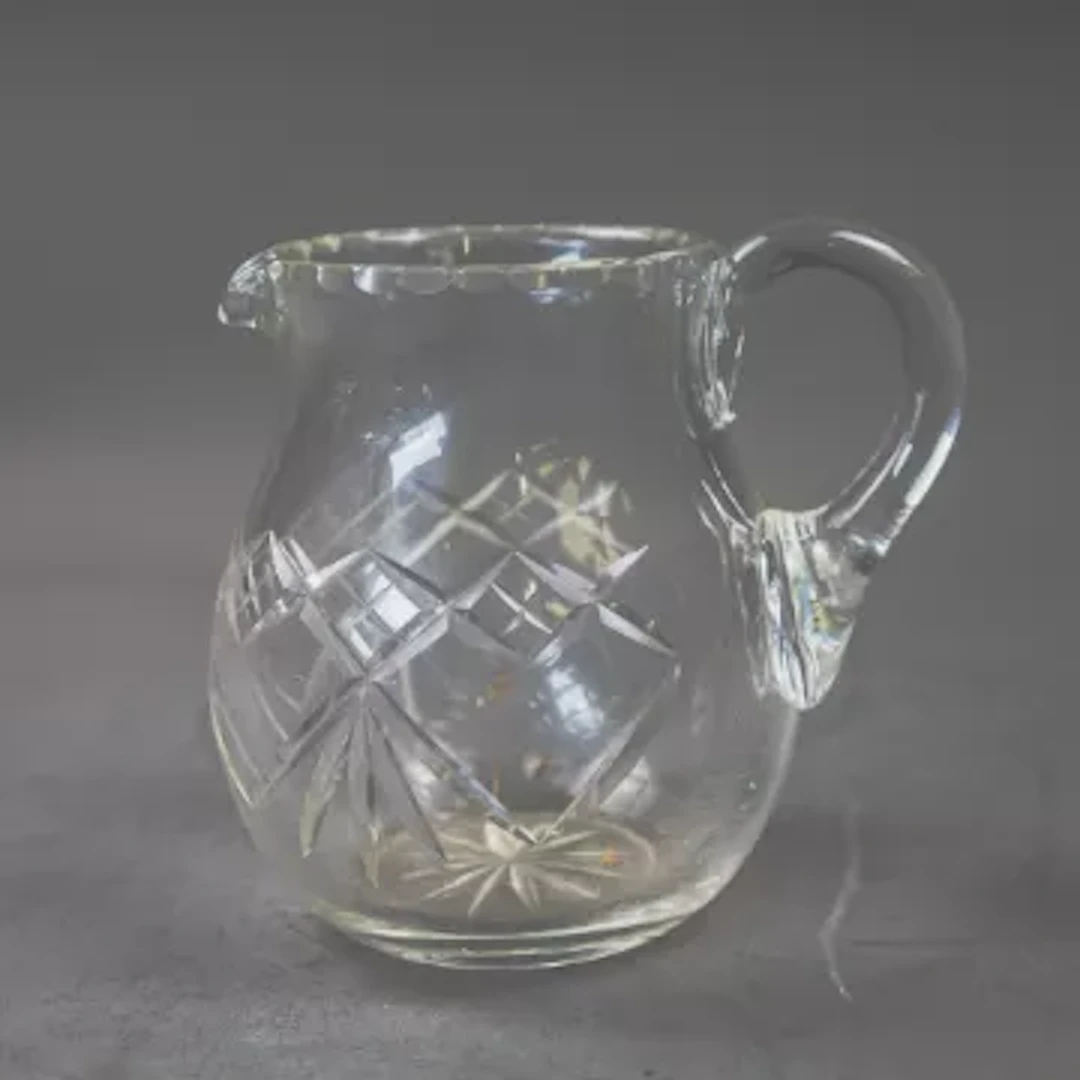 A cut crystal glass pitcher, cut diamond shaped pattern to body and