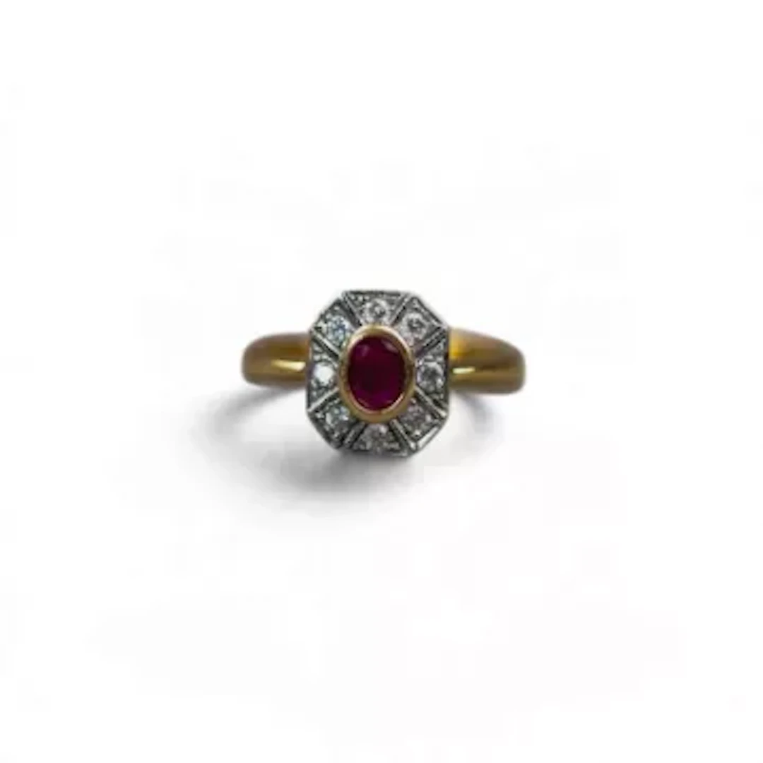 18ct gold ring, with bezel-set oval ruby framed by octagonal geometric