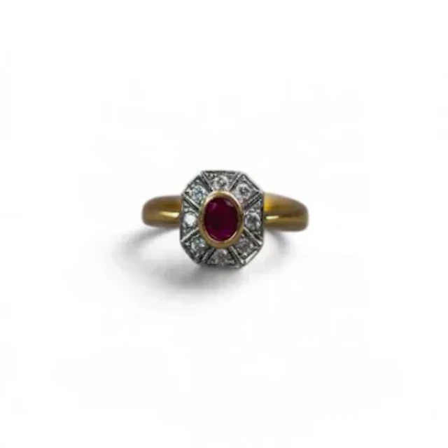 18ct gold ring, with bezel-set oval ruby framed by octagonal geometric