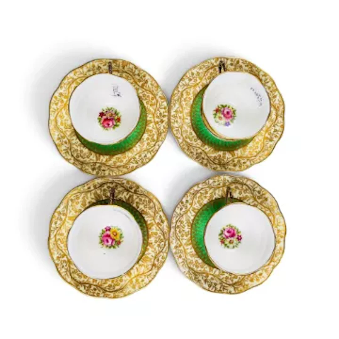 A group of 4 George Jones coffee cups and saucers in a floral design