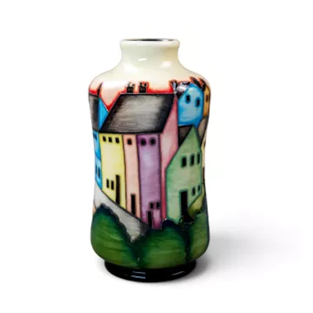 A Moorcroft trial vase, decorated with trees & houses in different