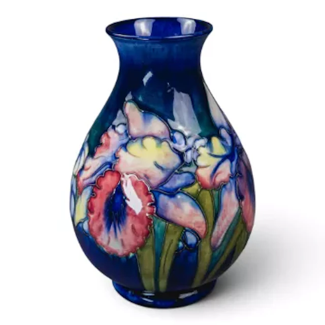 A Moorcroft vase in the Orchid design on a blue ground, by Walter