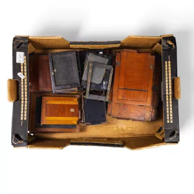 A mixture of vintage wooden and metal darkslide photographic plate