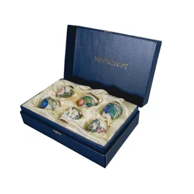 Moorcroft boxed set of six egg cups with Fruit & Blossom designs.