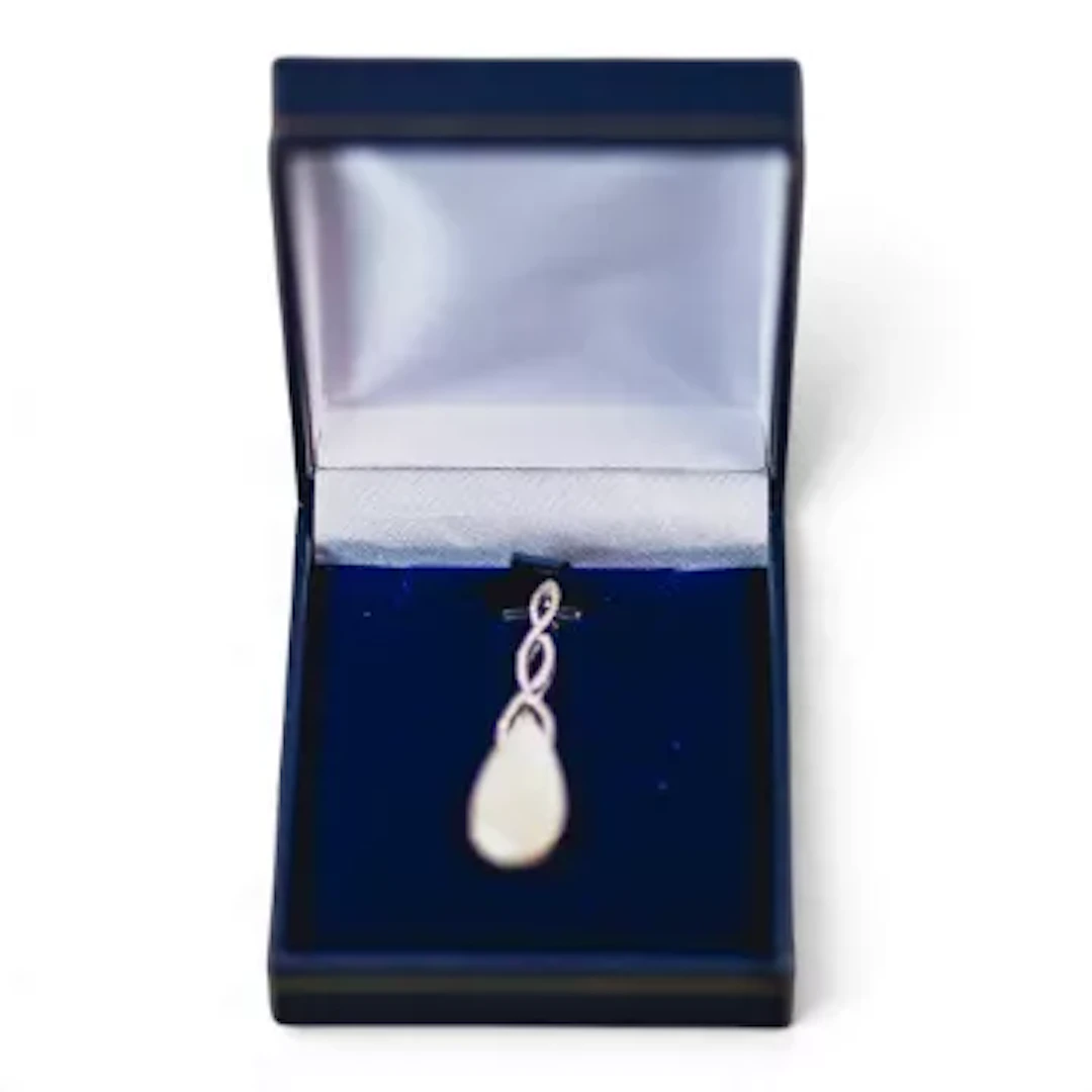 18k white gold and pear shaped opal with natural diamonds. From a