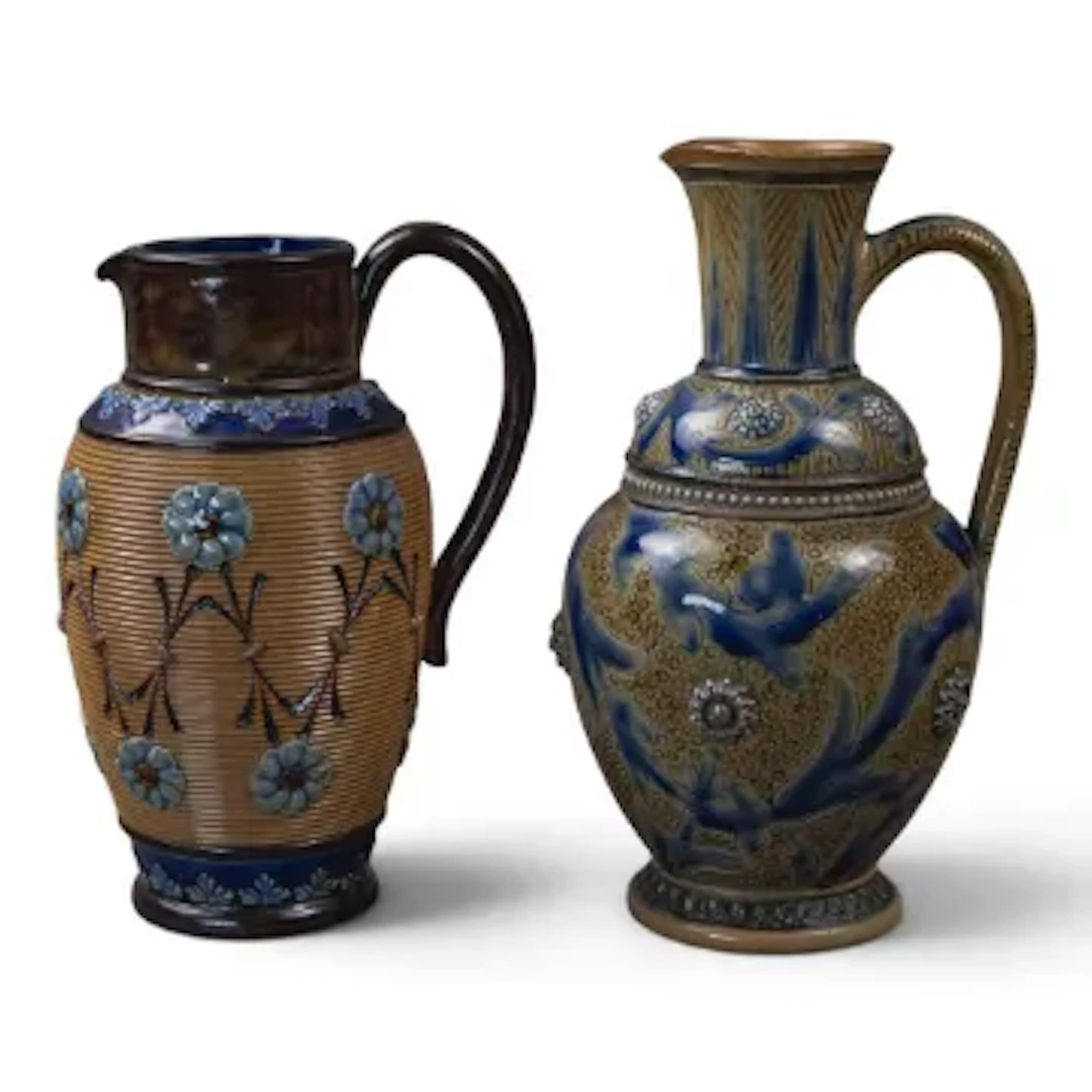 Two Doulton Lambeth jugs, tallest with a scrolling design and embossed
