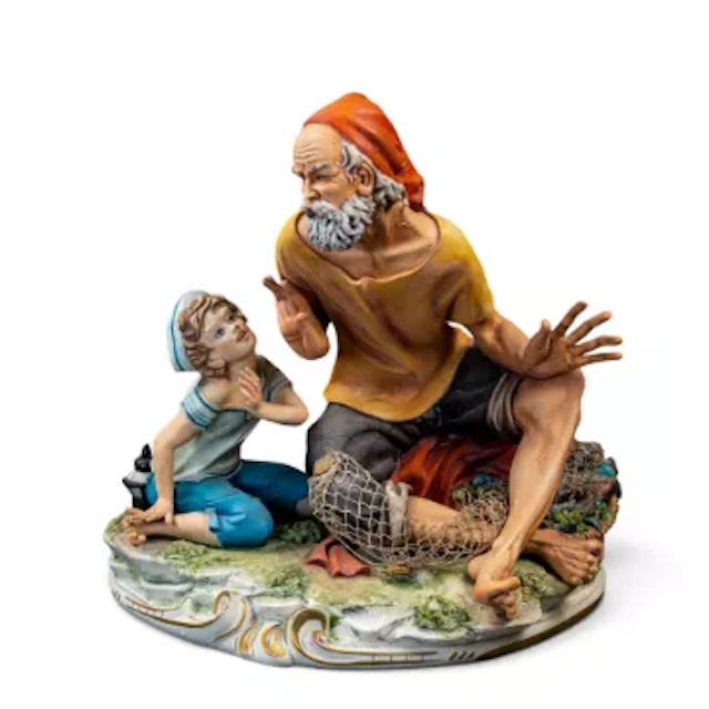 Large Capodimonte figural group depicting a fisherman and a boy, h.30cm.