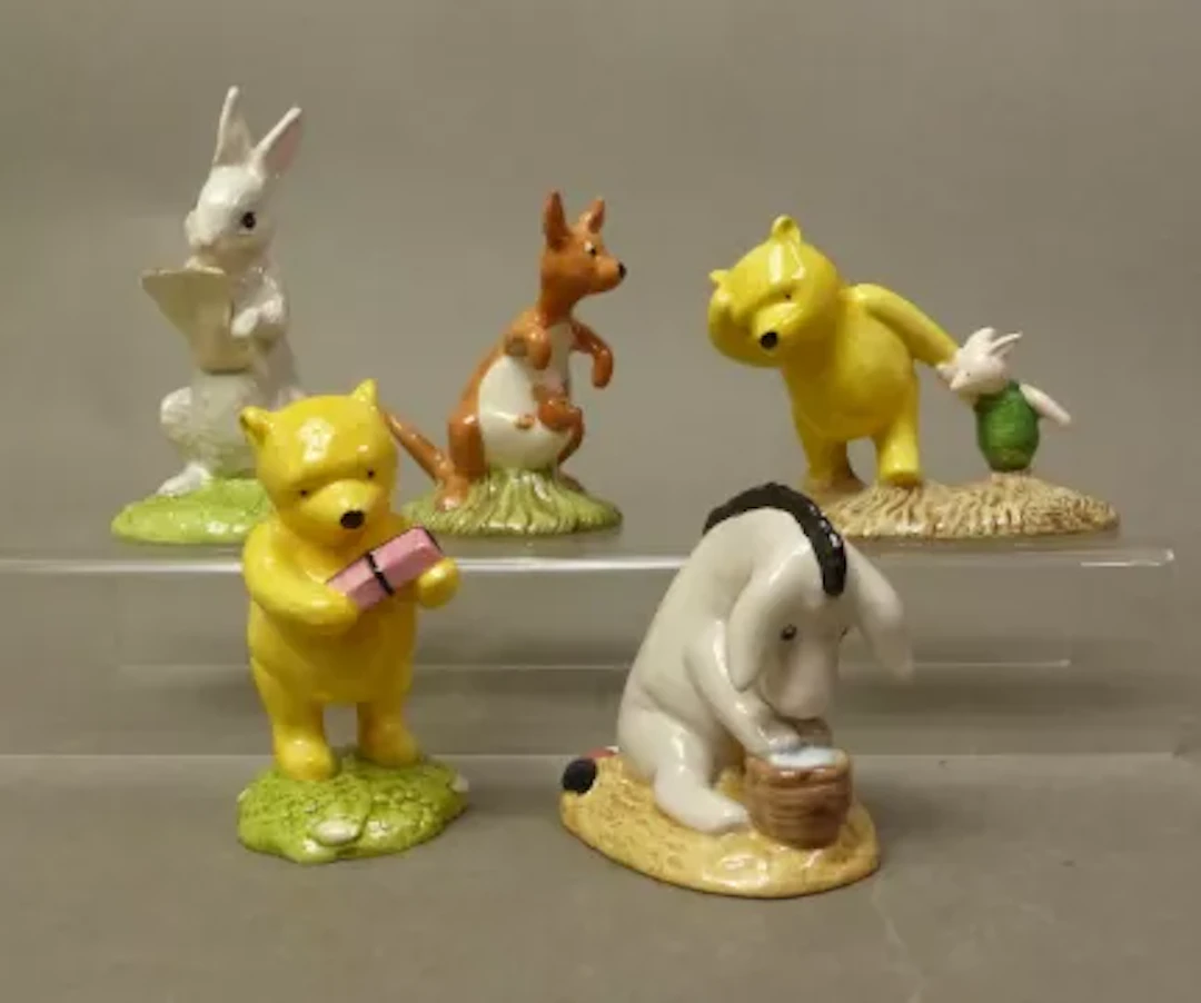 A collection of five Winnie the Pooh boxed figures, Eeyore's Birthday