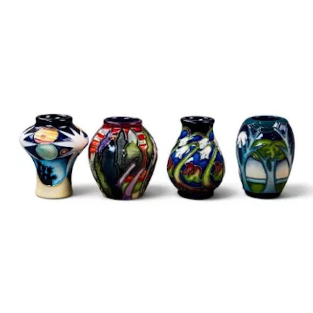 A group of four Moorcroft miniature vases, to include Lodge Hill