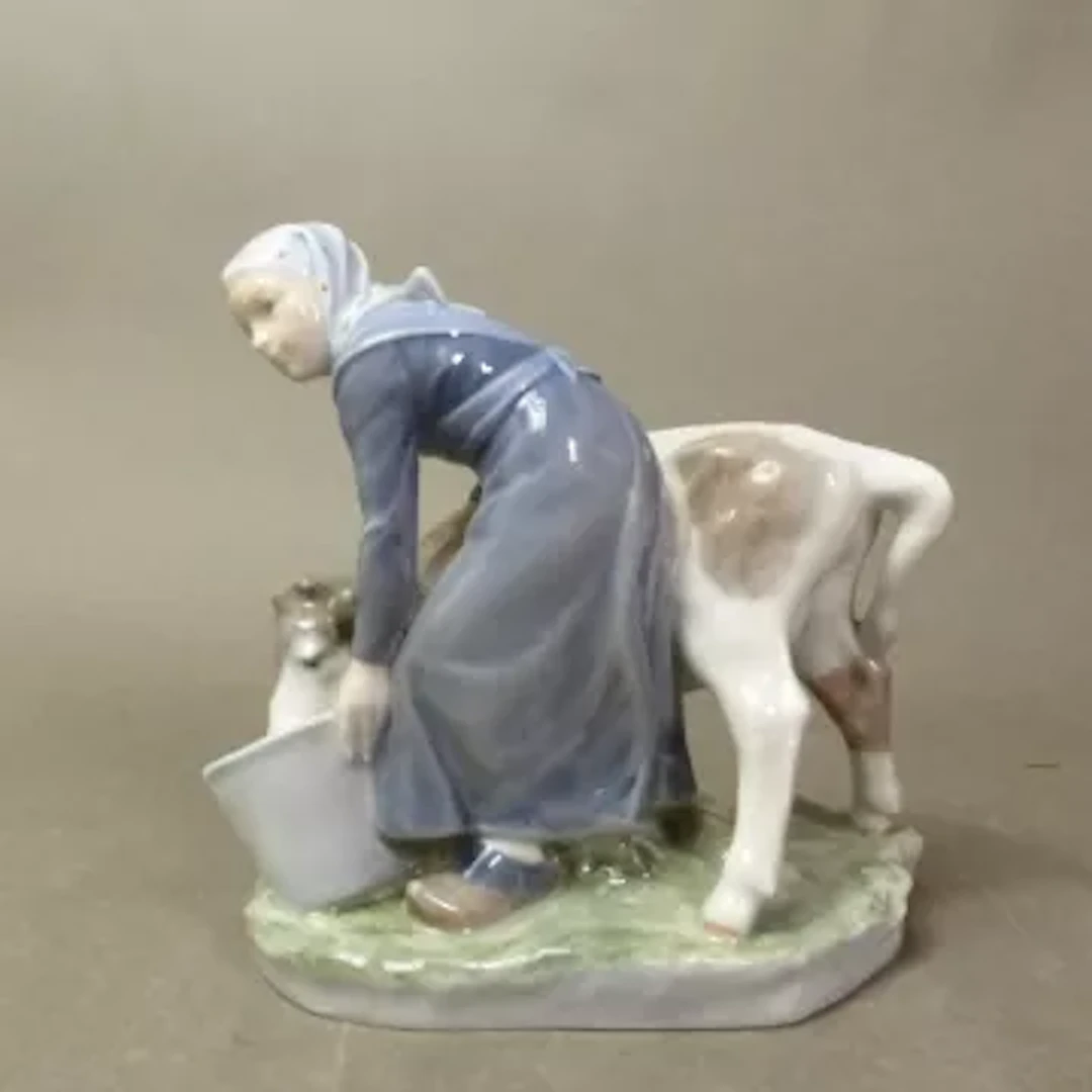 Royal Copenhagen figure Girl With Calf, designed by Christian Thomsen