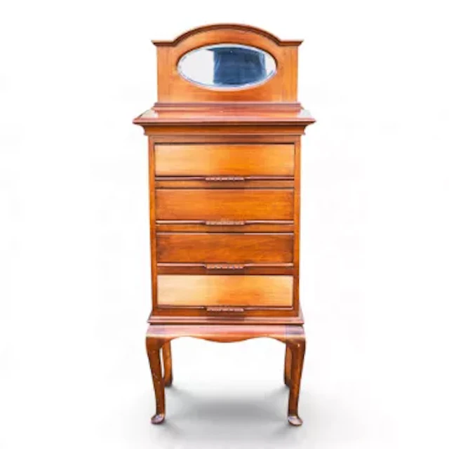 An Edwardian mahogany four drawer music cabinet featuring a small