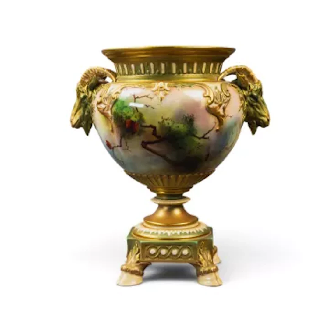 A Royal Worcester two handled urn vase, ornately gilded on a pedestal