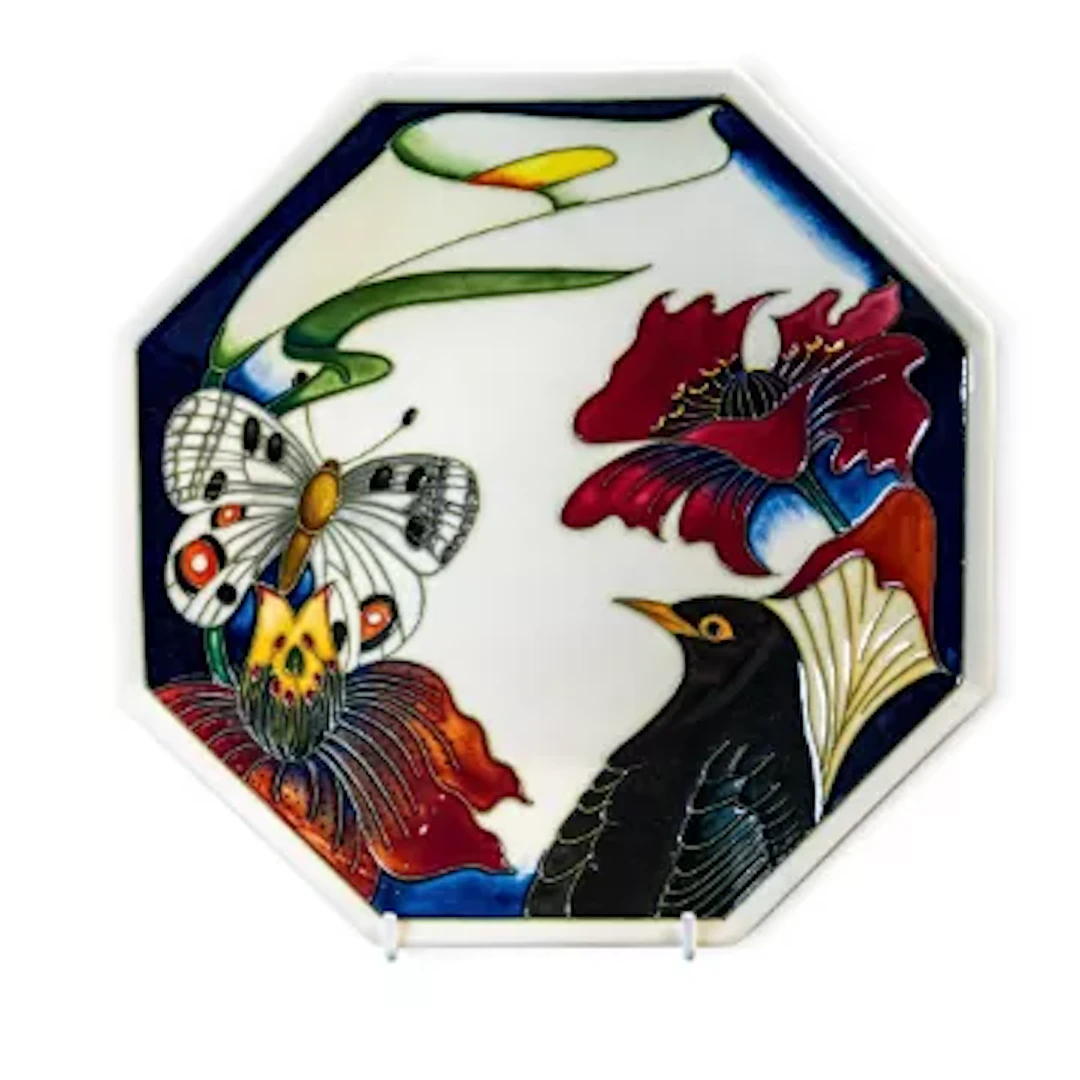 A Moorcroft plate in the Designers Medley design, from the Moorcroft