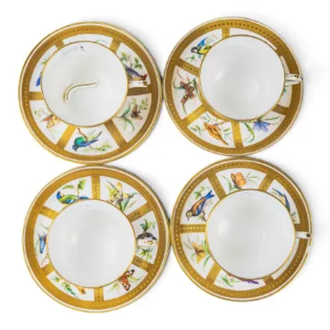 A group of 4 Minton cups & saucers, all decorated in panels featuring